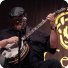 J.P. Cormier demonstrate his mastery over one of a number of stringed instruments at the Celtic Colours International Festival