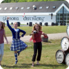 Three young performers pose outside the Glenora Distillery