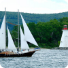 A sailing tour passes the Lighthouse in Baddeck, Victoria County